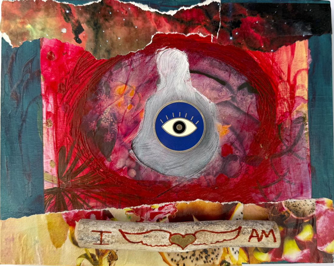 Collage on board: a silver figure with a blue eye charm over red paint and torn star photos, above a driftwood stick carved I AM with a winged heart.
