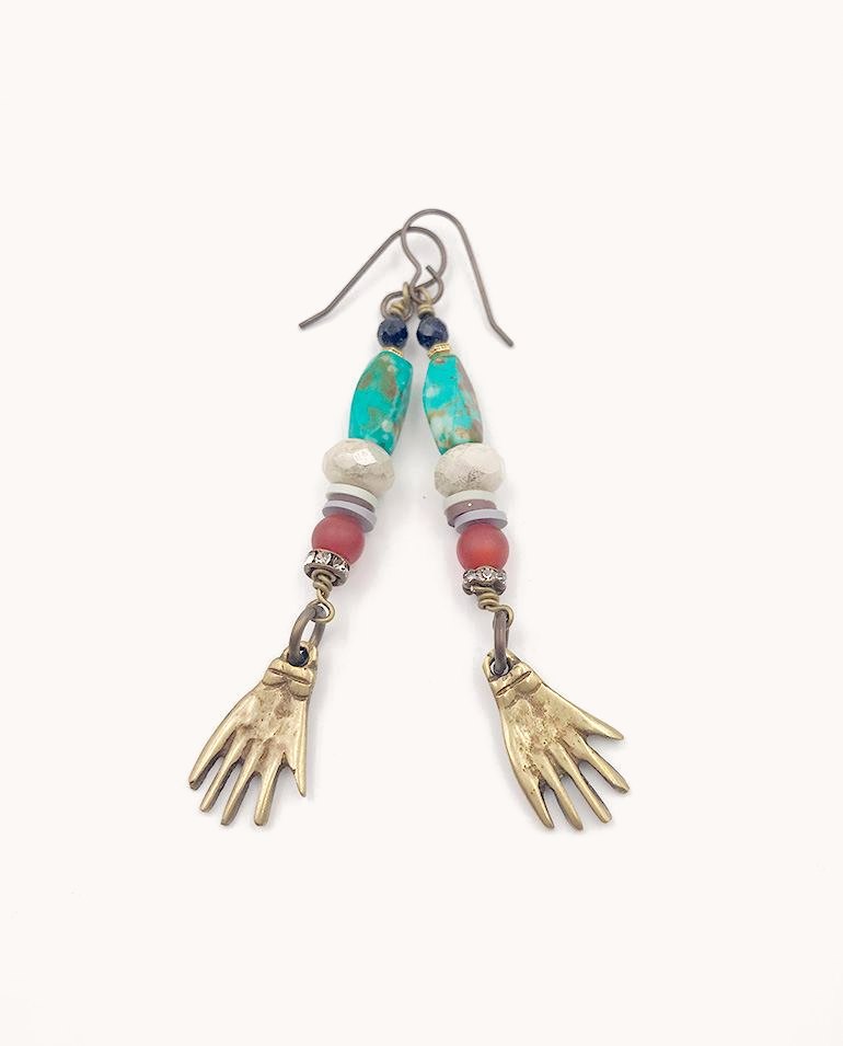 Long earrings with turquoise beads and small brass hands.