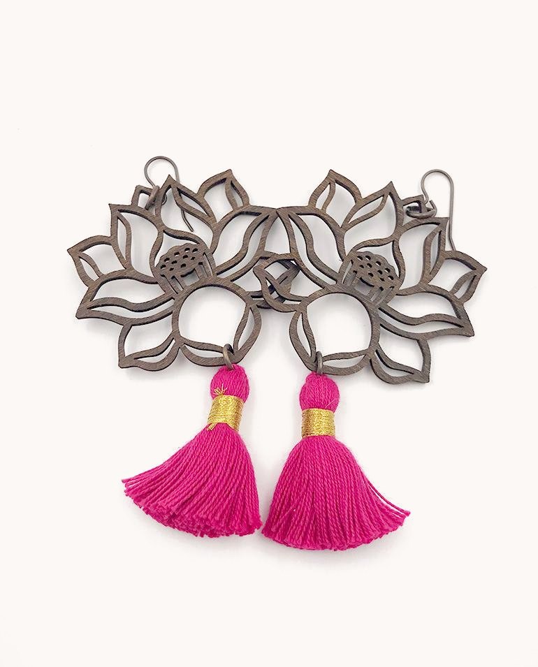 Pewter lotus earrings with hot pink tassels.