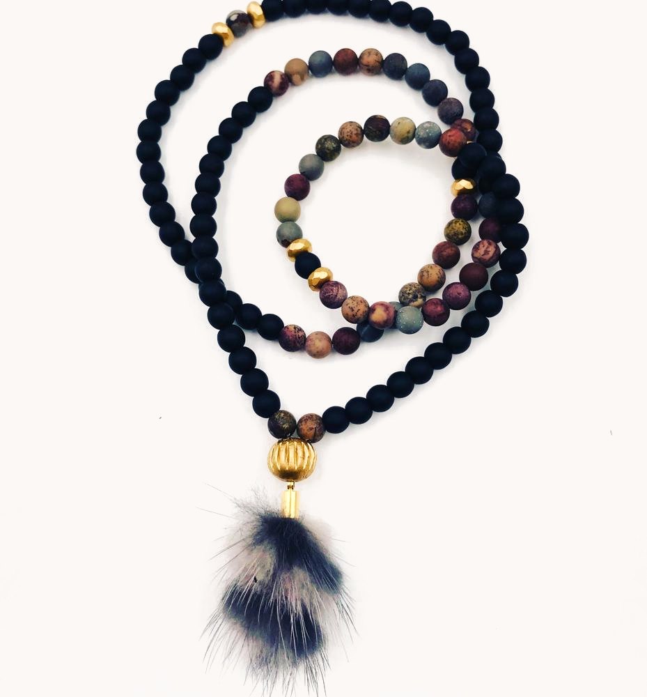 Black bead mala with mixed jasper beads, a gold bead and a fur tassel.