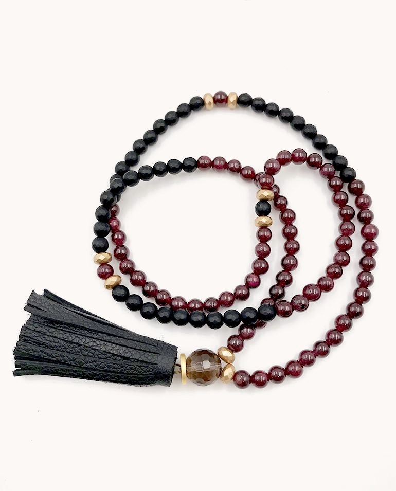 Garnet and black bead mala with a black leather tassel.
