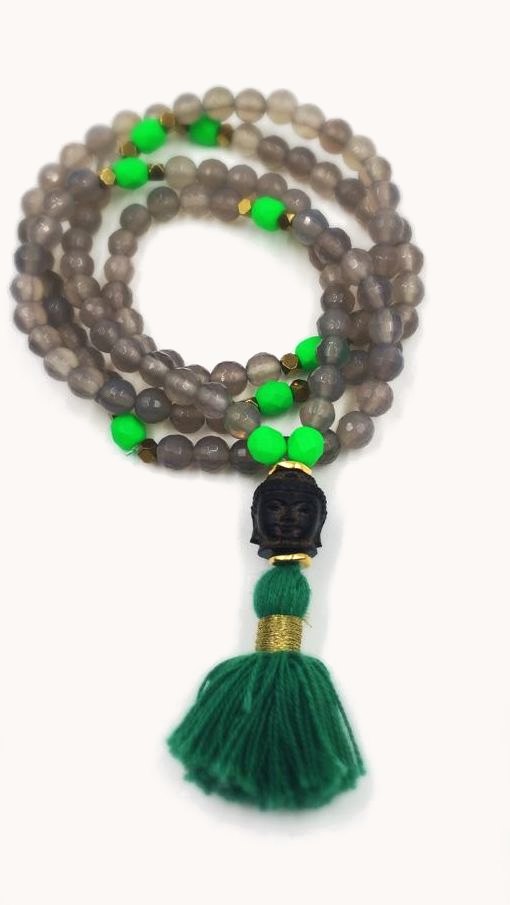 Grey bead mala with bright green accents and a green tassel.