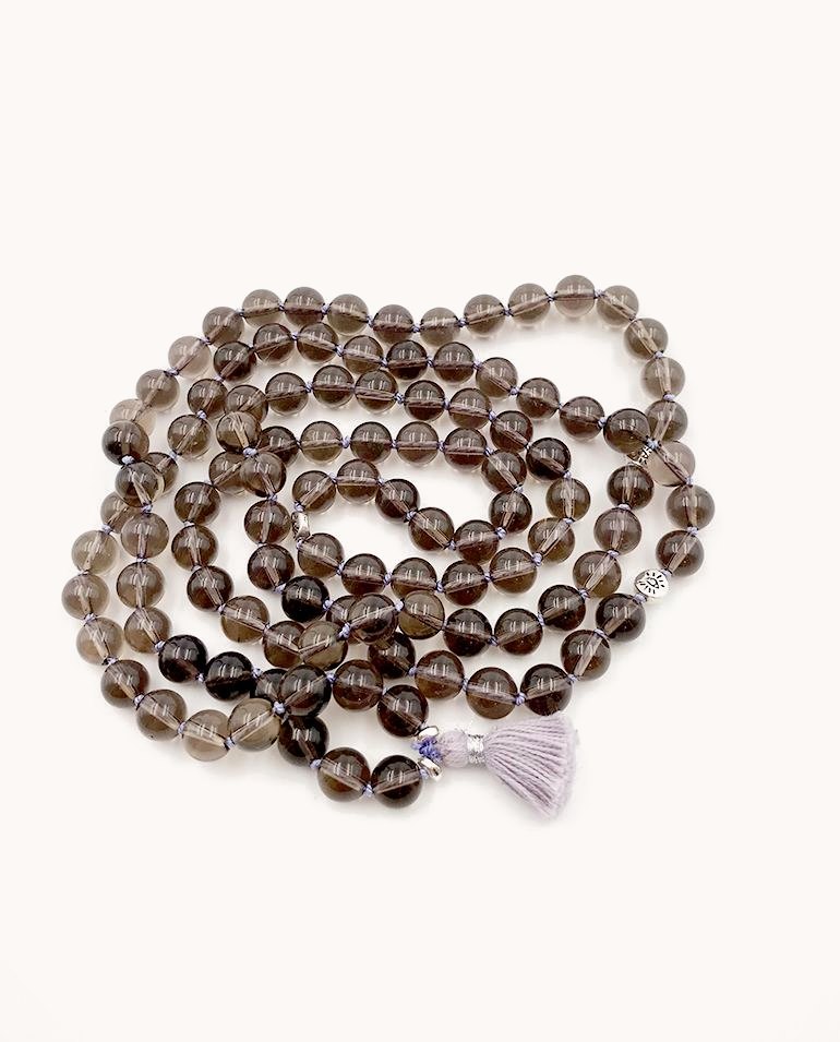 Smoky quartz mala with a pale lavender tassel.