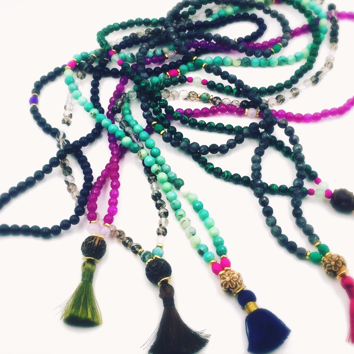 Long malas in black, teal and magenta with silk tassels.