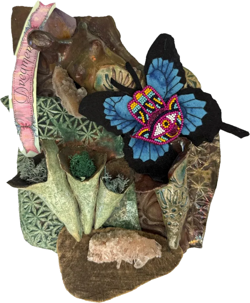 Glazed ceramic forms, crystals and moss with a beaded felt butterfly and a ribbon reading Dreamer.