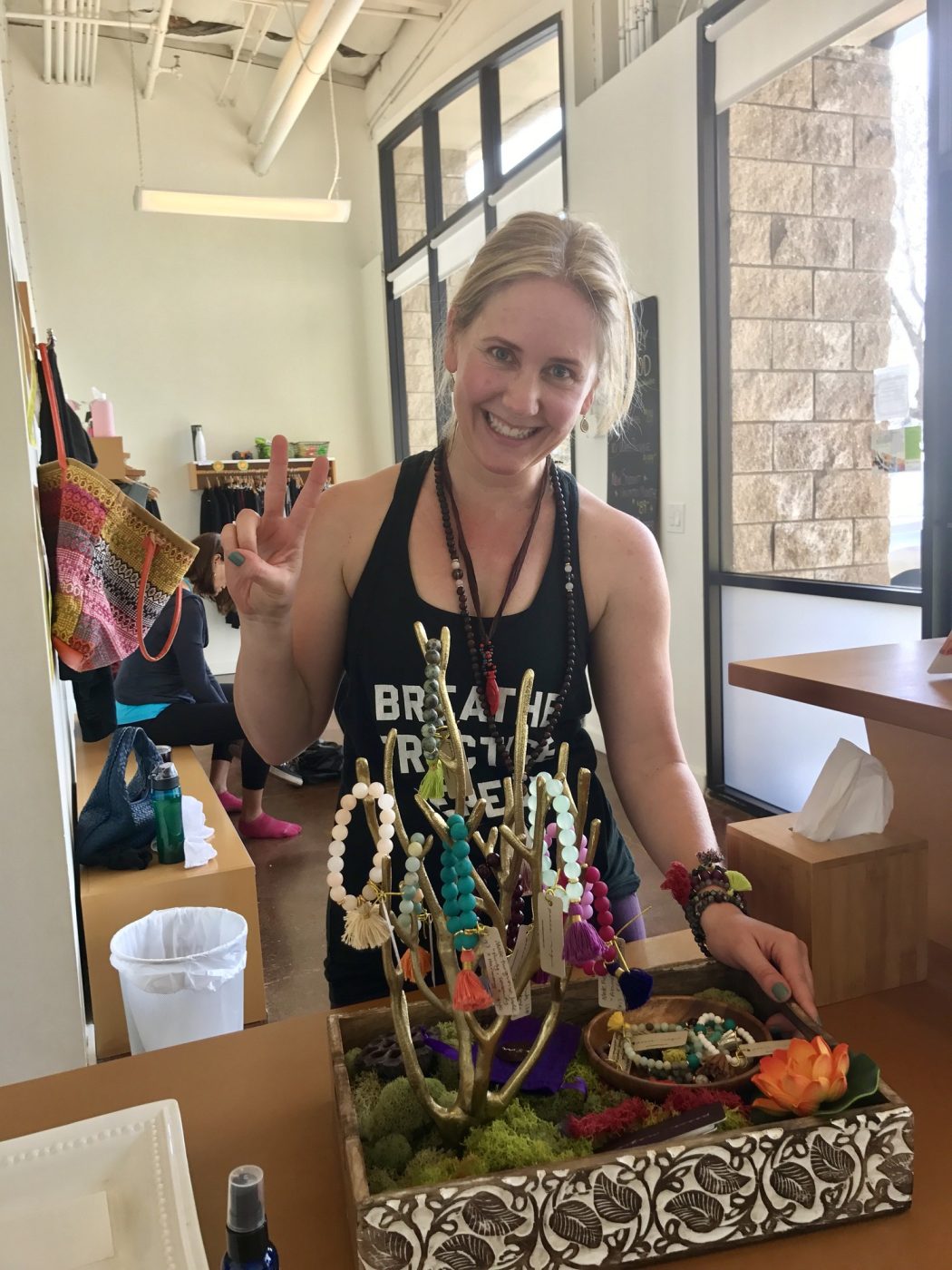 Amy at a yoga studio pop up with a jewelry display on a mossy tray.